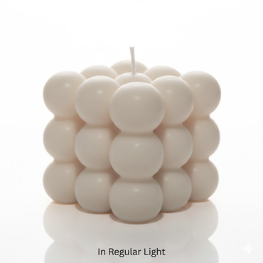Cylindrical candle with stacked sphere design on a white background
Glowing green candle with a cube-like bubble design on a black background
Sensations Unleashed BDSM Glow in the Dark Wax Play Big Bubble Candle In India
