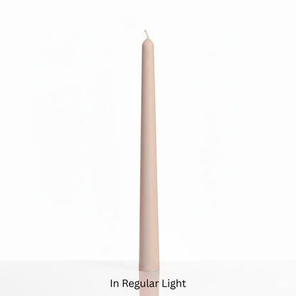 Beige candle on a white background with text 'In Regular Light'. Sensations Unleashed BDSM Glow in the Dark Wax Play Tapered Candle In India